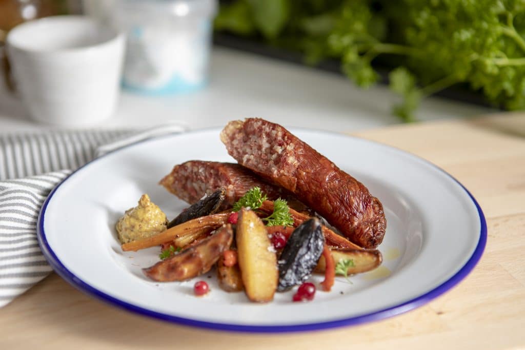 Klassiska småländska isterband serverade med ugnsrostade rotfrukter, lingon och senap. 